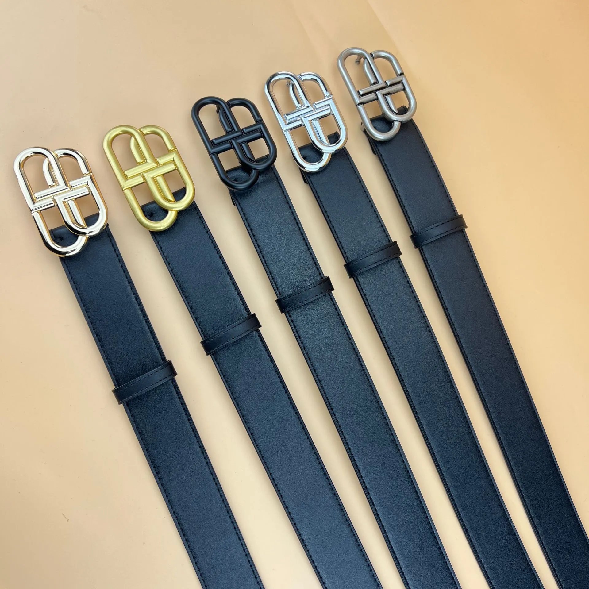 Five leather belts with different buckle finishes