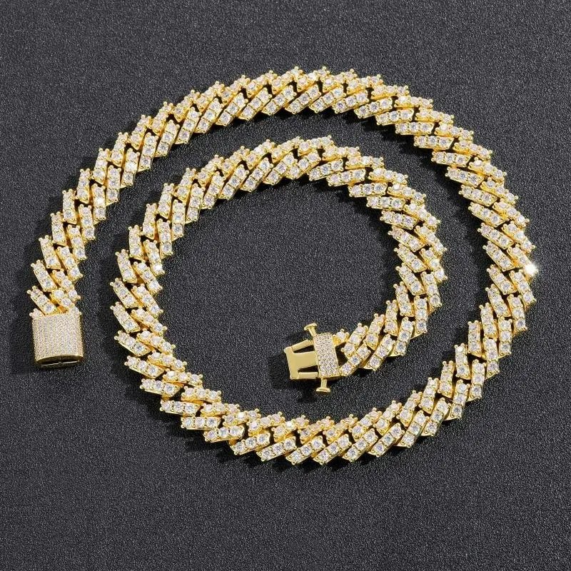 Gold-tone chain necklace coiled on a dark surface